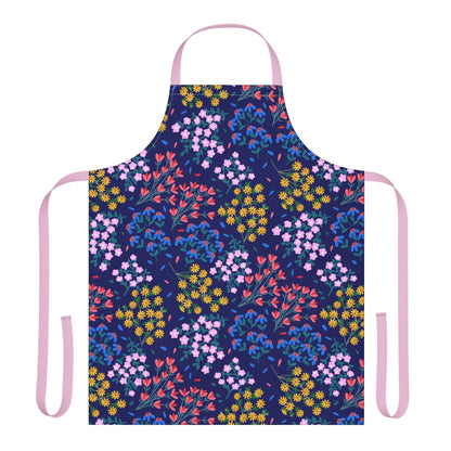 Floral Apron featuring a navy-blue background adorned with clusters of small pink, red, yellow, and blue flowers, complemented by pale pink neck loop and waist ties, embodying FireBrook Designs' blend of comfort and joyfulness.