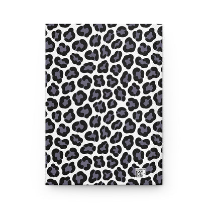 HARDCOVER JOURNAL, MATTE, RULED, 5X7, SEWN BIND, CLEAN-TEAR PAGES – LEOPARD, NEUTRAL COLOR features a white cover with stylized black leopard spots, includes a tiny QR-style code for product identification.