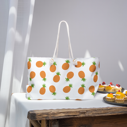 Weekender Bag - Pineapple Pattern: A stylish, spacious bag with orange pineapple motifs and cream rope handles, perfect for travel. Made of durable spun polyester, ideal for summer getaways and adventures.