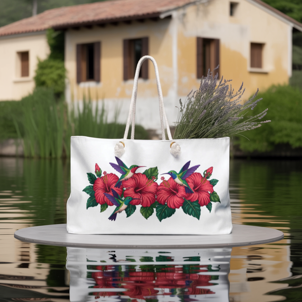 Tote Bag with hummingbirds and hibiscus design, featuring sturdy rope handles and gold grommets, perfect for stylish weekend trips. Ideal for travelers seeking unique, uplifting designs by FireBrook Designs.